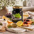 Jar of Cavi-ah Citrus balsamic pearls with gold lid, alongside cheese, crackers, lemon and topped crostini
