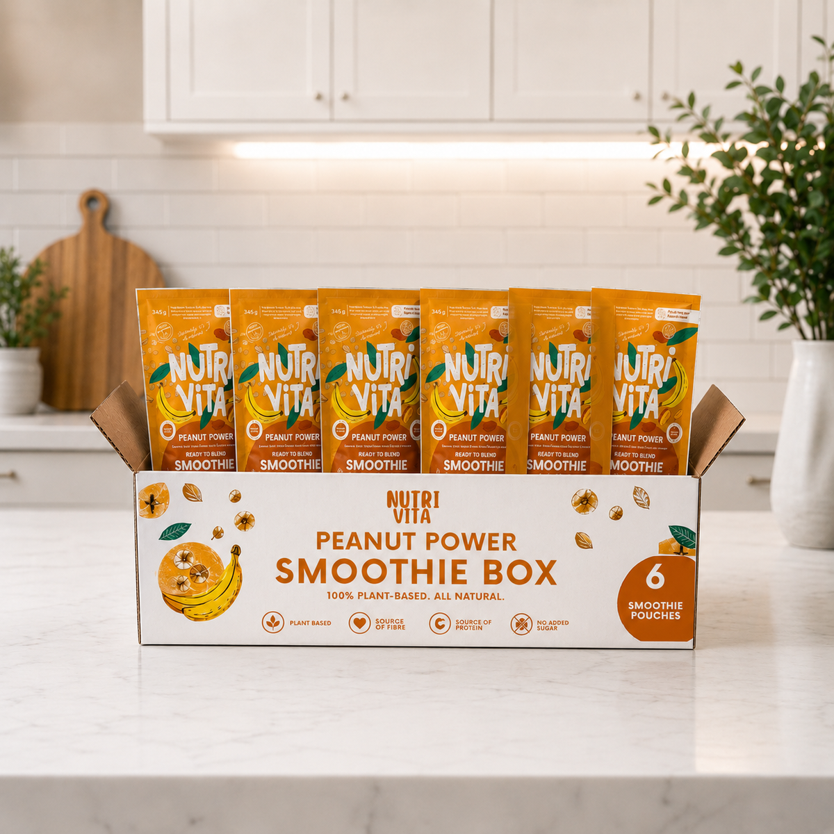 Open Peanut Power Smoothie Box with six orange smoothie pouches on a kitchen counter