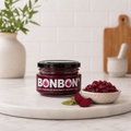 Jar of BonBon's handmade beetroot chutney beside a bowl of chunky chutney and sliced beetroot
