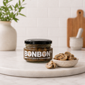 Jar of Bon Bon's balsamic pickled button mushrooms beside a bowl of sliced mushrooms