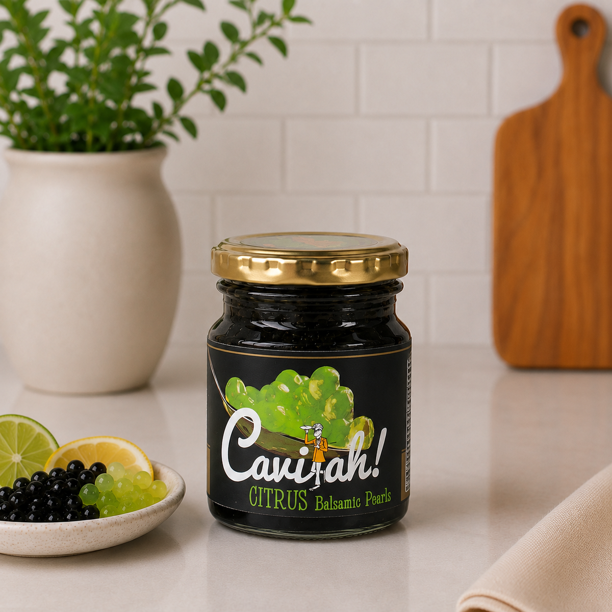 Jar of Cavi-ah Citrus balsamic pearls with gold lid, beside black and citrus pearls