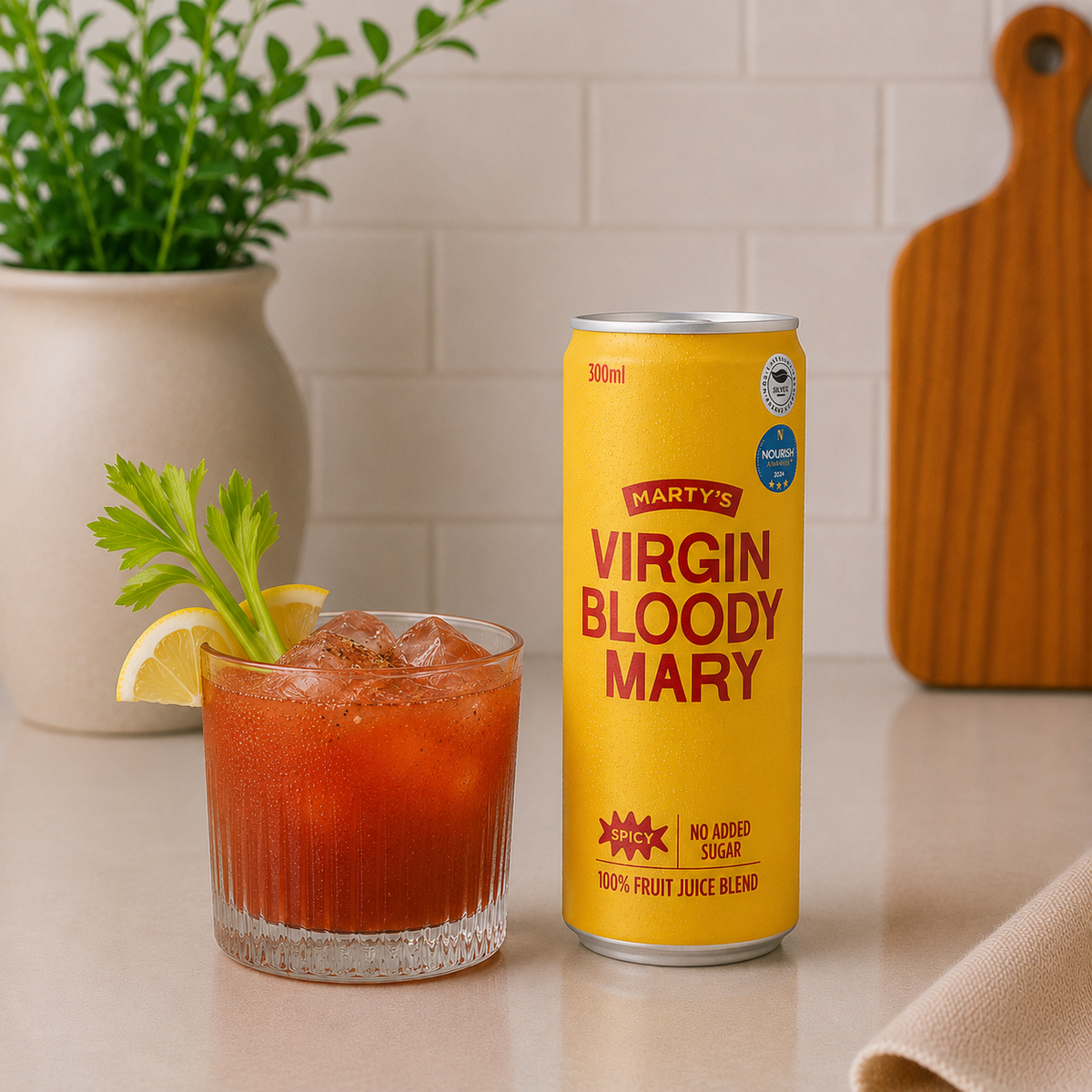 Can of Marty's Virgin Bloody Mary beside an iced glass garnished with celery and lemon