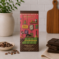 Honest Dark Mylk vegan chocolate bar in illustrated pink packaging beside stacked chocolate pieces