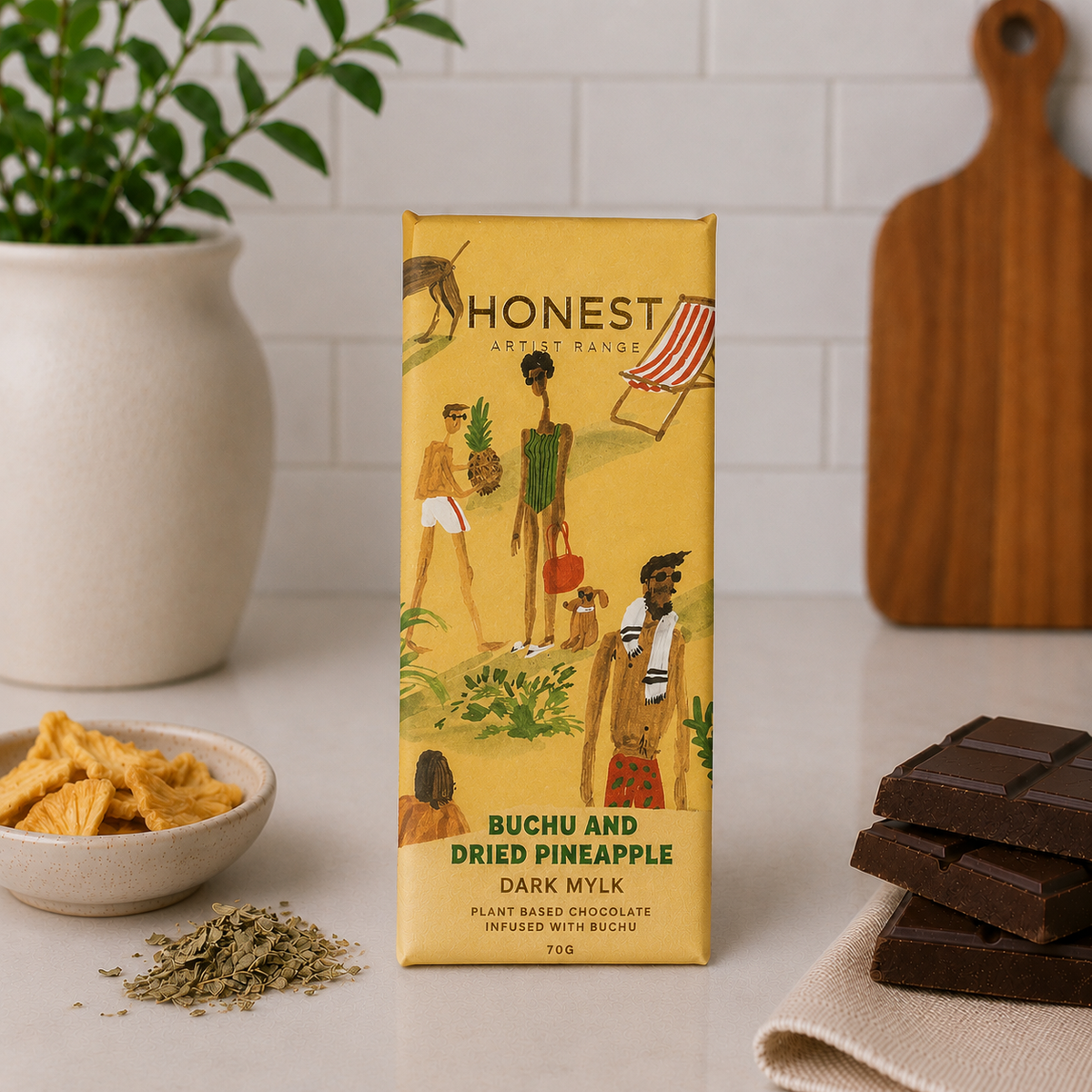 Honest buchu and dried pineapple dark milk chocolate slab in illustrated yellow packaging with chocolate pieces