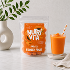 Nutri Vita papaya frozen fruit pouch beside a glass of orange papaya smoothie