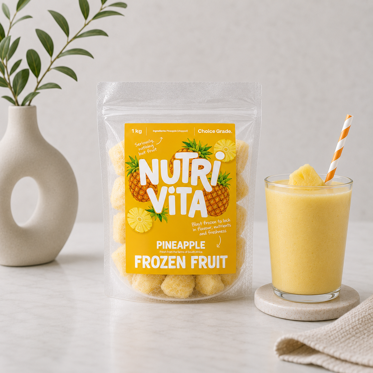 Nutri Vita pineapple frozen fruit pouch beside a glass of pineapple smoothie