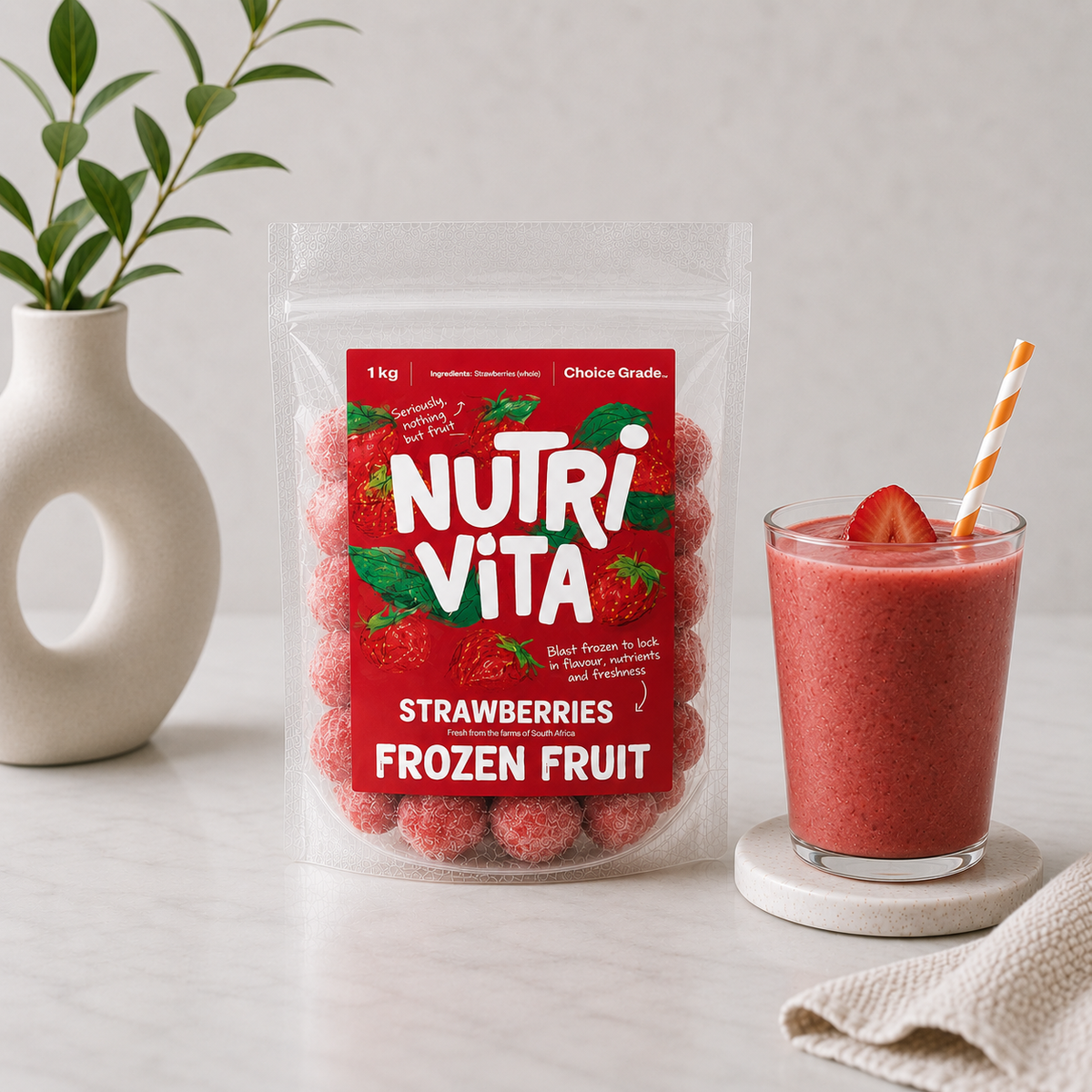 Bag of Nutri Vita frozen strawberries beside a strawberry smoothie garnished with fresh fruit