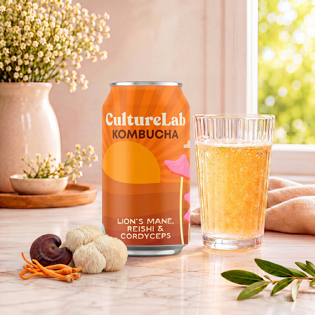 CultureLab kombucha can with lion's mane, reishi and cordyceps beside a glass of amber kombucha