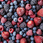 Close-up of frozen strawberries, raspberries, blueberries and blackberries coated with frost
