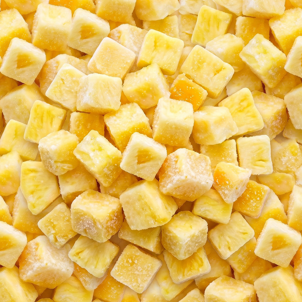 Close-up of yellow frozen pineapple chunks coated with frost