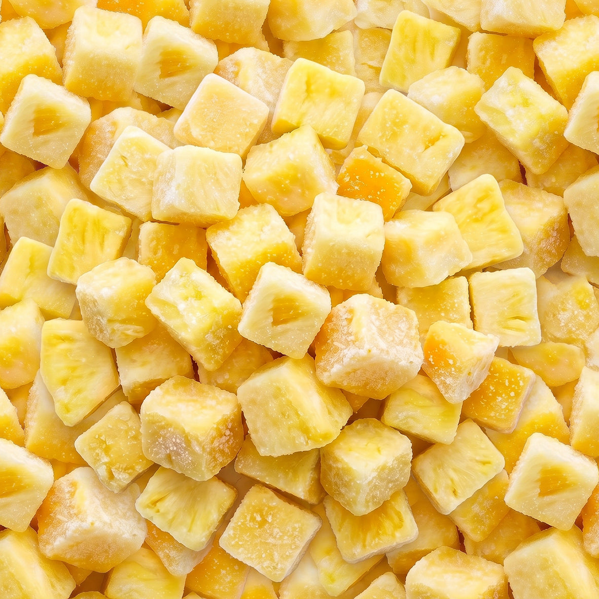 Close-up of yellow frozen pineapple chunks coated with frost